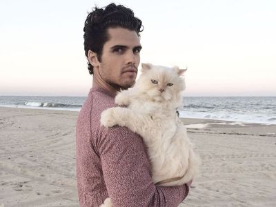 Brian Shimansky and Nick are at the beach as Brian is carrying Nick by his arms.